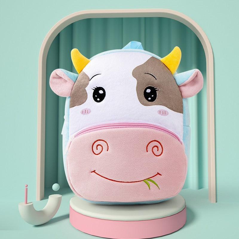 Plush children’s kindergarten backpacks featuring cute animal designs including a ladybug, cow, bunny, tiger, and butterfly, displayed on colorful blocks.