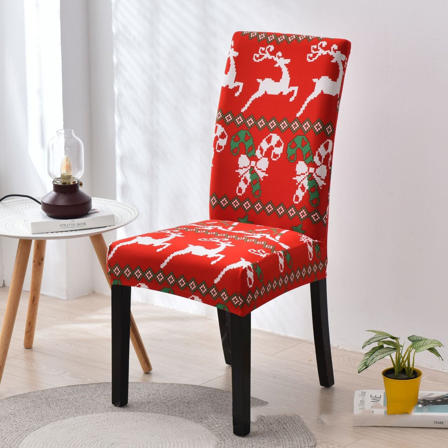Bright red Christmas chair cover featuring festive white reindeer and green candy cane patterns. Designed to fit standard dining chairs, it brings holiday cheer to any room. The cozy fabric and intricate details, including diamond-shaped borders and holly leaves, make it perfect for Christmas home decor ideas. Ideal for enhancing seasonal aesthetics and creating a warm, welcoming ambiance. Shop festive chair covers now!