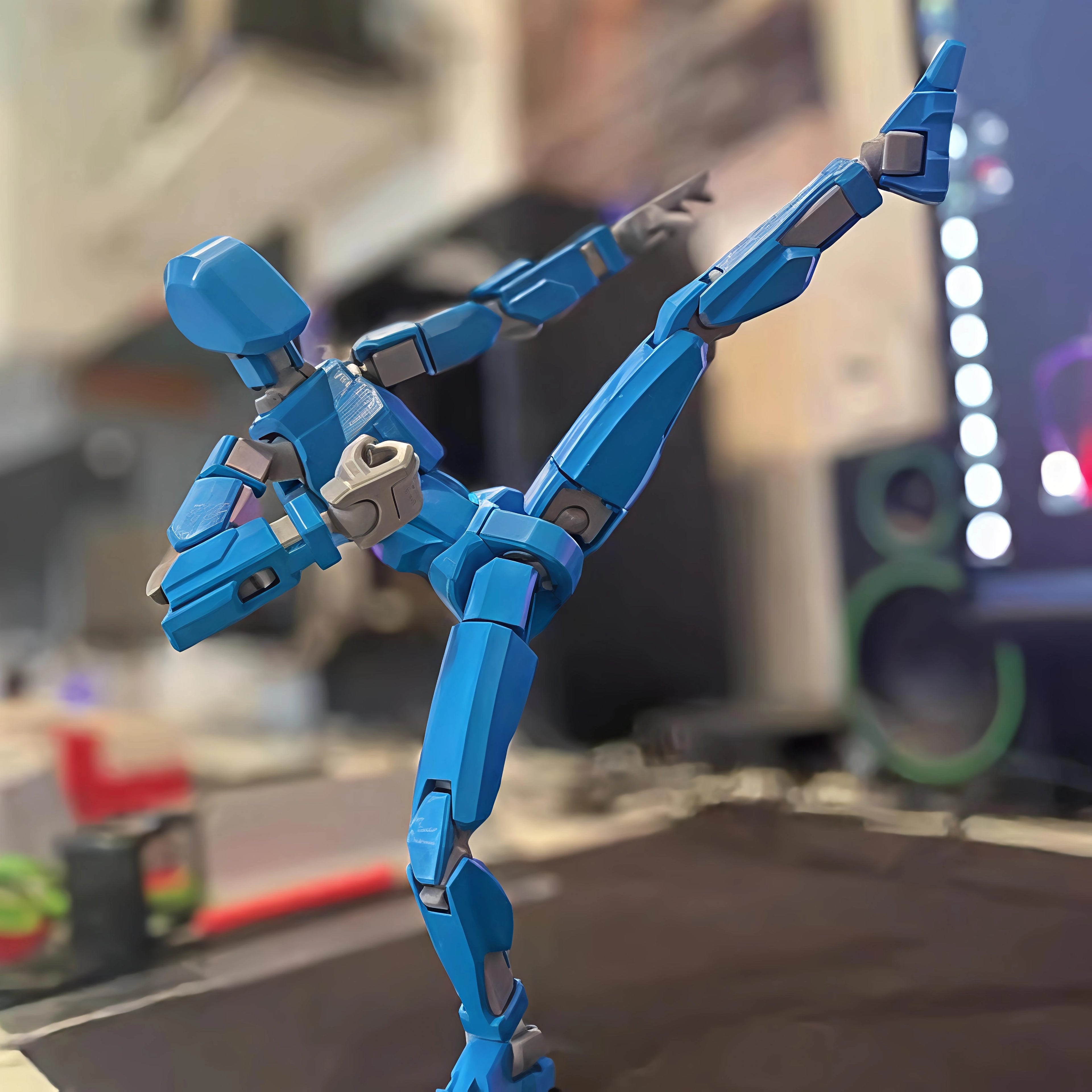 Blue robot toy figure on a blurred background