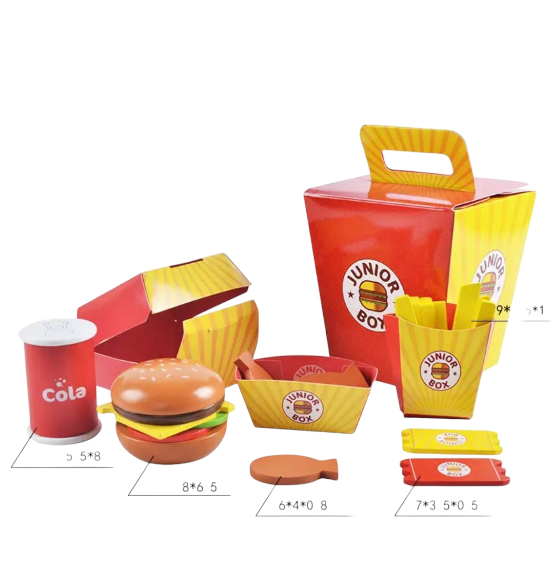 A colorful pretend play fast food set for children featuring toy items resembling a 'Junior Box' meal. The set includes a hamburger with a sesame seed bun, a box of fries, chicken nuggets, cola can, and condiment packets. Designed for imaginative play and fun for kids.