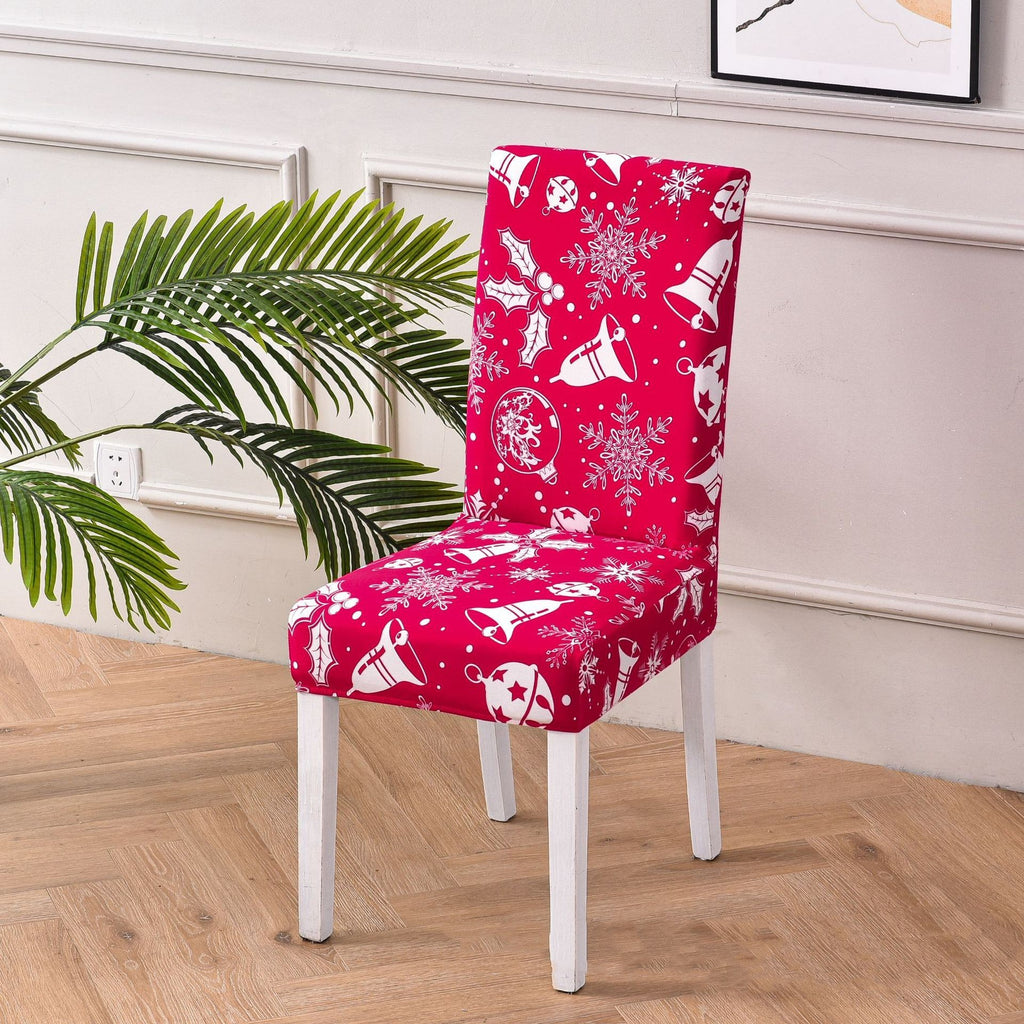 Festive red chair cover with white Christmas-themed patterns, including bells, snowflakes, holly leaves, and ornaments. Perfectly designed to fit dining chairs, this holiday decor item brings a warm and cheerful vibe to any room. Ideal for Christmas home decorations, seasonal parties, and enhancing holiday ambiance. Stylish, snug fit with easy-to-clean material—add festive charm to your furniture today!