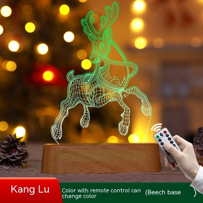 Illuminated Christmas LED lamps with a 'Merry Christmas' sign featuring reindeer antlers and a Christmas tree with presents underneath. The lamps glow warmly, set against a backdrop of a decorated Christmas tree with lights and ornaments. Pine branches and a pine cone add to the festive ambiance.