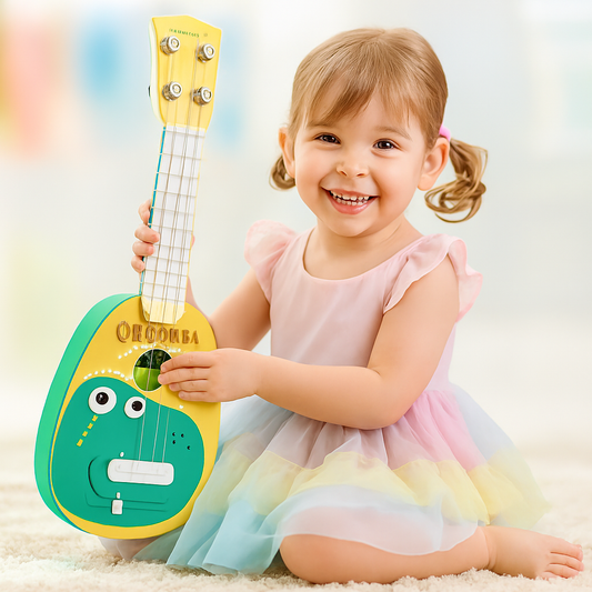 Smiling toddler playing with a colorful dinosaur-themed toy guitar—designed to spark musical curiosity and imaginative play. Available now at Giggly Groves.