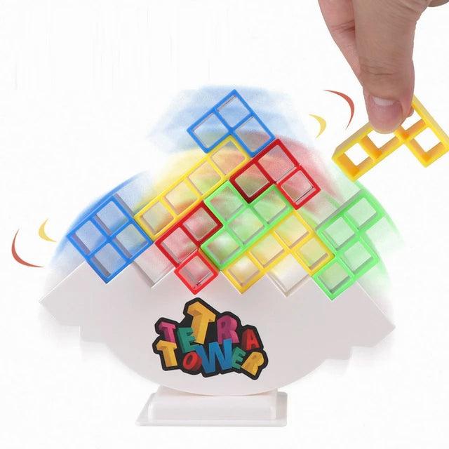 Image of a colorful 48-piece stacking toy for kids named 'Hot High Swing Russian Balancing Blocks'. The toy features vibrant hollow blocks in green, blue, red, and yellow, stacked on a white balancing base. A hand is shown placing a blue block onto the stack. Fun and educational, this table toy is available on Giggly Groves.