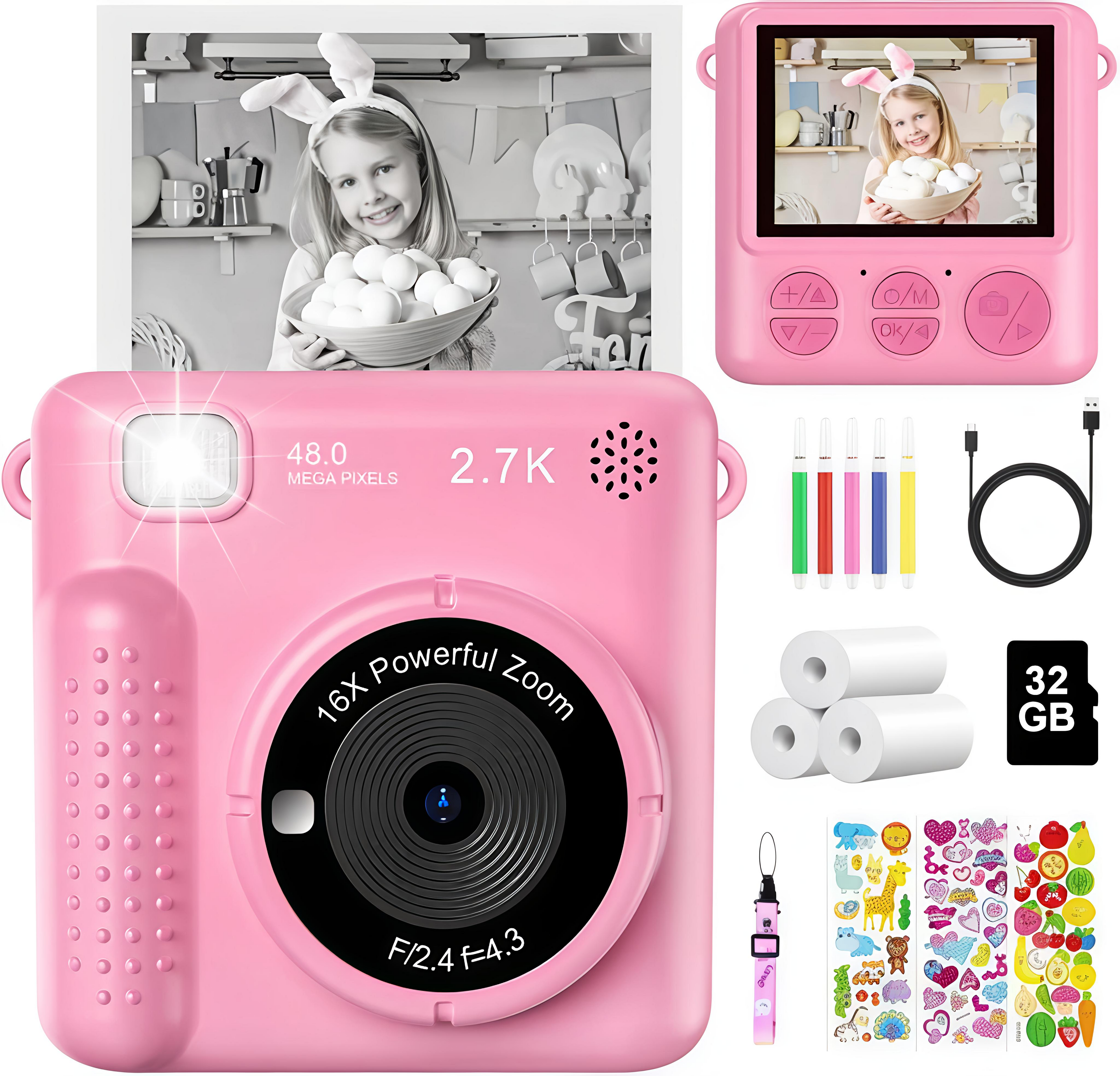 Pink digital camera with accessories including a screen, cable, paper rolls, and stickers.