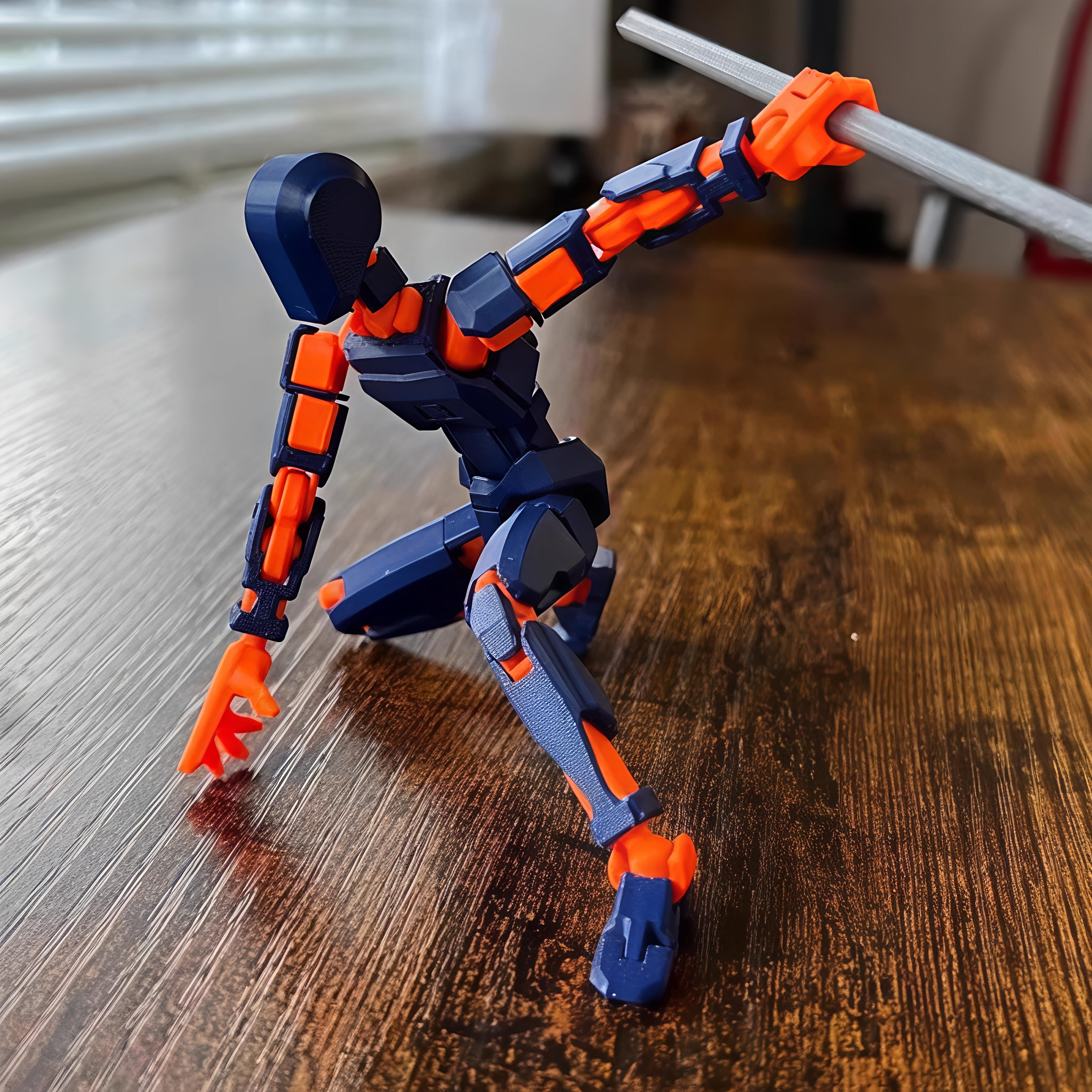 Toy figure with blue and orange details on a wooden surface